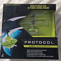 Front view of Protocol Aura remote control UFO in original packaging showing product details and clear window display.
