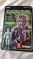 Front view of Iron Maiden Glow Aces High Pilot Eddie ReAction figure new on card