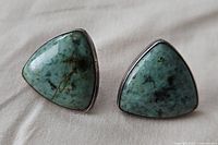 Front view showing triangular polished African turquoise stones set in sterling silver.