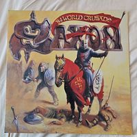 Front cover of the tour program showing illustrated knight on horse with Saxon band logo and World Crusade banner.