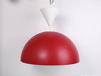 Full view of red dome-shaped pendant ceiling lamp hanging from white plastic cone