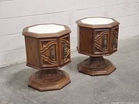 Pair of vintage hexagon nightstands with laminate tops, hexagonal shape and carved doors shown from front angle.