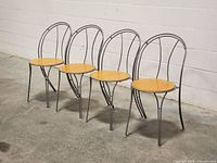 Four chairs arranged in a row at a slight angle, showing frame and seat details.