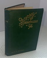 Front cover of the hardcover book featuring the title 'The Insurrection of 98' with gold embossed lettering and harp design on a dark green background.