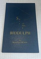 Front cover of the hardcover book showing title and author embossed in gold on dark blue background