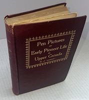 Front angled view of book showing burgundy cover with gold embossed title and border, slightly open to show page edges and spine wear.