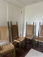 Four vintage woven rush chairs front view