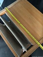 Top view showing wood surface, sling and tape measure length