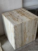 Single travertine cube table showing top and two sides