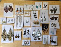 Overview of all 25 earring pairs displayed on individual white cards