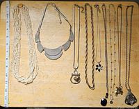 All nine necklaces laid flat for full view of styles and lengths