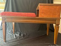 Full view of wooden telephone bench showing seat and side table