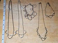 Five jewellery pieces laid out showing overall styles and count
