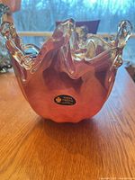 Oblique view of bowl showing color gradient, ruffled rim and White Cristal sticker