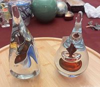 Front view showing both glass paperweights on tray