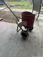 Overall view of spreader showing hopper, frame and wheels