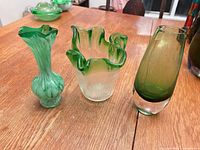 Three hand-blown glass vases on table showing overall lot