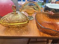 All three amber glass pieces side by side on table