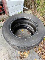 Pair of Goodyear Wrangler tires stacked on ground