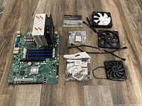 Top view of motherboard with cooler, CPUs, fans, cables, hardware bag