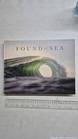 Front cover of the book 'Found at Sea' showing a detailed photograph of a wave with the title and author's name.