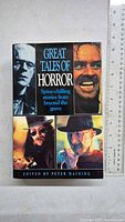 Front cover of 'Great Tales of Horror' hardcover book showing horror character montage and title design.