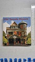 Front cover of the 'Old Toronto Houses' hardcover book with a color image of a historic Toronto house with a turret.