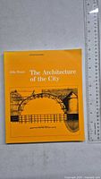 Front cover of the book 'The Architecture of the City' showing title, author, and architectural drawing illustration.