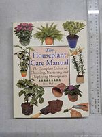 Front cover of 'The Houseplant Care Manual' showing various houseplants and the title prominently.