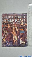 Front cover of the hardcover book showing the title, detailed artwork of Native South American cultural motifs, and a ruler showing size.