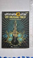Front cover photo of the Ultimate Guitar Tab Treasure Chest book showing title, artwork, and publisher.