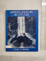 Front cover of 'Water in Landscape Architecture' book showing title, author, and a black and white image of a water feature.