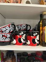 Shelf view showing Mickey and Minnie Mouse themed mugs and soup bowls