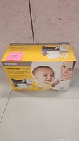 Front and top view of Medela Pump In Style double electric breast pump box showing branding and product image.