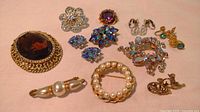 Overhead view of all jewelry items displayed on pink fabric background