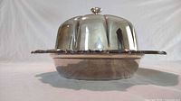 Side view of the silver plated serving dish with domed lid, showing its rounded form and knob.