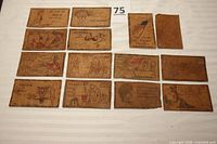 All 14 leather postcards laid out