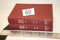 Two maroon cloth hardcover volumes stacked with spine titles visible and ruler for scale
