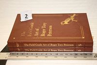 Spines and front cover showing title and bird motif, ruler for scale