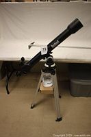 Full view of Bushnell refractor telescope mounted on tripod