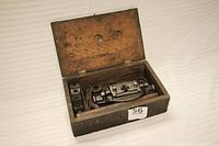 Open wooden box showing threader and components