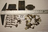 Overview of three locks, ruler for scale, skeleton keys and modern keys