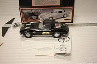 Black 1963 Corvette decanter, box, paperwork, measuring tape showing 13 in