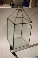 Terrarium front view showing glass panels and metal frame, ruler for scale