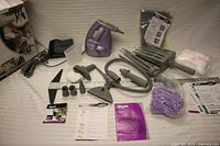 All components of Shark steam cleaner kit laid out including main unit, hose, attachments, pads, manuals