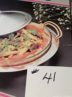 Box showing dish with silvertone lid and handled base