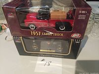 Both boxed die-cast banks stacked showing front packaging and models