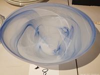 Top view of frosted glass bowl showing blue swirls