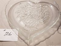 Full view of heart-shaped tray showing embossed floral basket