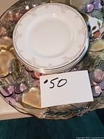 Stack of Royal Doulton plates on top of glass platter